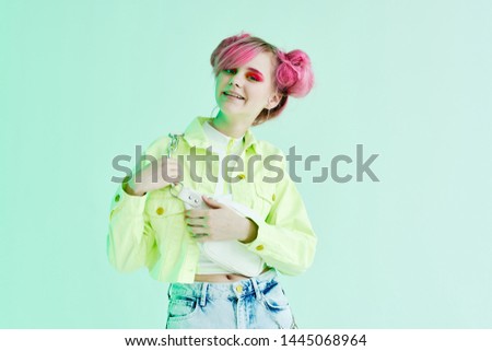 woman with pink hair in a green jacket