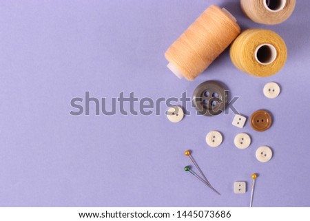 sewing accessories on a colored background top view.
