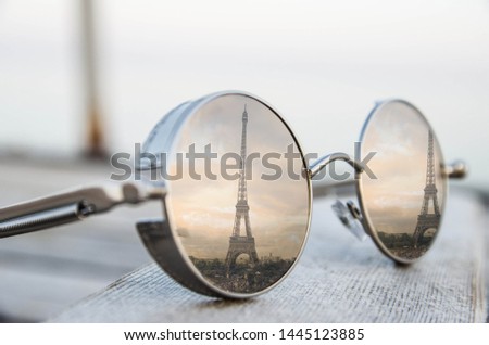 The picture shows the reflection of the Eiffel Tower in polarized glasses. Horizontal photo.
