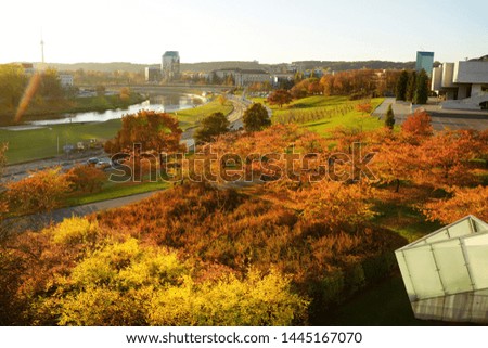 Colorful city park scene in the fall with orange and yellow foliage. Beautiful autumn scenery in Vilnius, Lithuania.