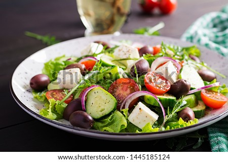 Greek salad with fresh vegetables, feta cheese and kalamata olives. Healthy food. Royalty-Free Stock Photo #1445185124