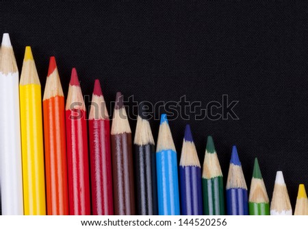 Color pencils isolated on black background