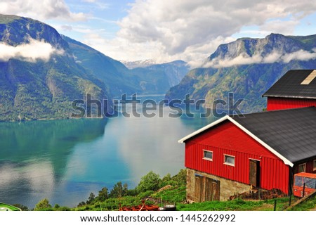 Red scandinavian house over Sognefjord, Norway  Royalty-Free Stock Photo #1445262992