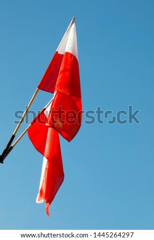 White and red flags of Poland are seen against blue sky in Zakopane , Poland