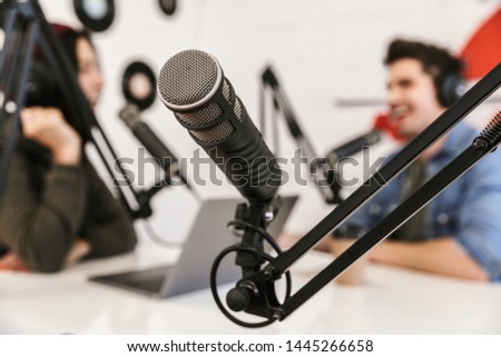Two radio hosts moderating a live show for radio