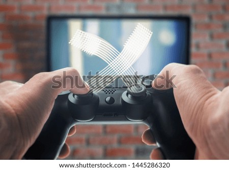Playing video games. Gamepad in hand
