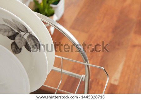 Kitchen with various kitchen tools, background with kitchen racks and plants. The appearance of drying dishes and bowls.