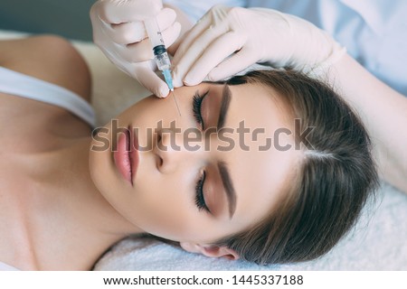 beauty injections into beautiful face. smoothing of mimic wrinkles around the eyes using biorevitalization Royalty-Free Stock Photo #1445337188