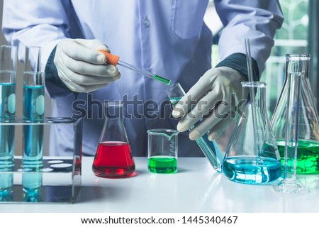 Researcher with glass laboratory chemical test tubes with liquid for analytical , medical, pharmaceutical and scientific research concept. Royalty-Free Stock Photo #1445340467