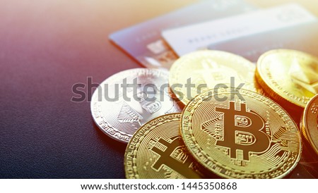 Digital assets are multi-coin bitcoin coins and credit cards. Is a financial technology based on blockchain, background sunset light Royalty-Free Stock Photo #1445350868