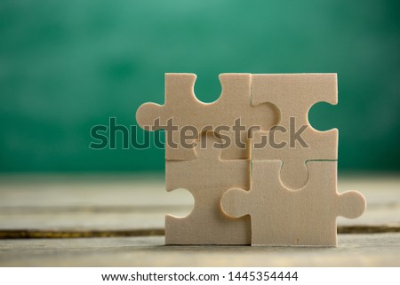 Creative solution for idea - business concept, jigsaw puzzle on the green blackboard background Royalty-Free Stock Photo #1445354444