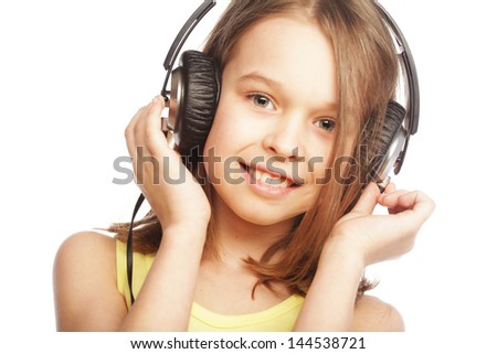 The girl is holding the headphones and smile