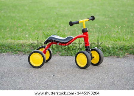 Red yellow children's bike on street