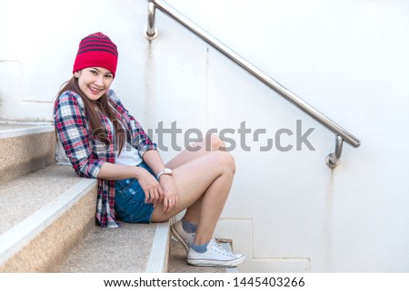 Portrait of beautiful asian hipster girl on stair background,Lifestyle of modern woman,Thailand happy woman take a photo concept