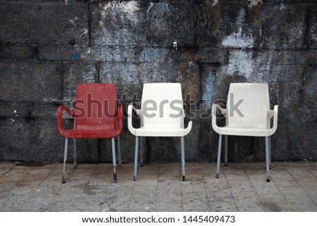 Three old chairs found in the port of Naples, Italy.