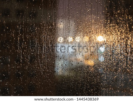 Rain drops. Rain drops on glass on a dark background