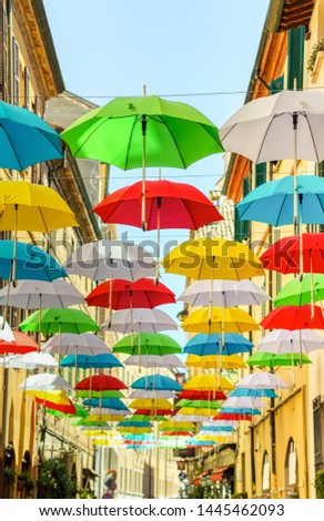 Colorful umbrellas hanging in street of historical center of Ravenna, Italy