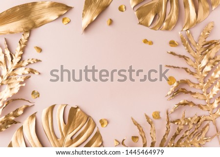 Flat lay of golden tropical leaf design elements. Decoration elements for invitation, wedding cards, valentines day, greeting cards. isolated over white background. Top view