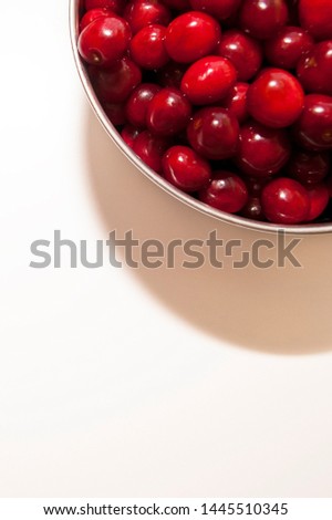 Bowl of cherries on a white background. Red cherries. Bowl placed on top lright corner of the frame