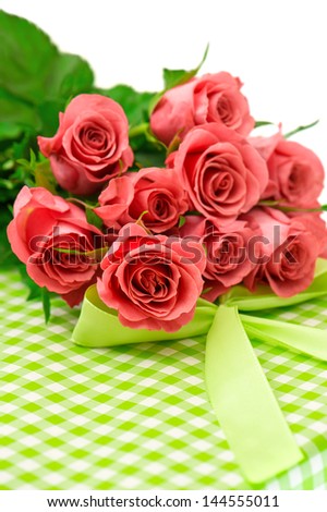 fresh pink roses with gift over white background. festive flowers arrangement