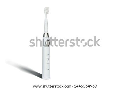 White sonic toothbrush for cleaning teeth on a white background. Medical and dental concept. Caring for teeth, modern methods of removing calculus from teeth. Electric toothbrush.