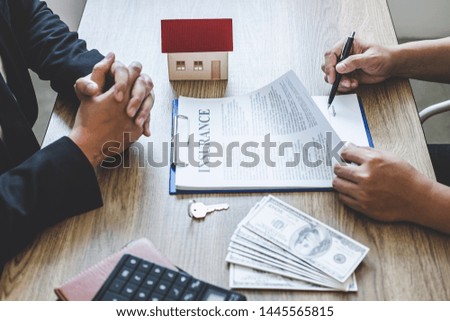 Estate agent broker reach contract form to client signing agreement contract real estate with approved mortgage application form, buying or concerning mortgage loan offer for and house insurance.