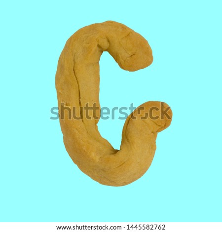 The letter G made from pastry, which can be eaten.
