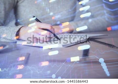 Double exposure of writing hand on background with data technology hologram. Big data concept.