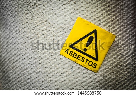 Asbestos warning sign in a old facility. Royalty-Free Stock Photo #1445588750