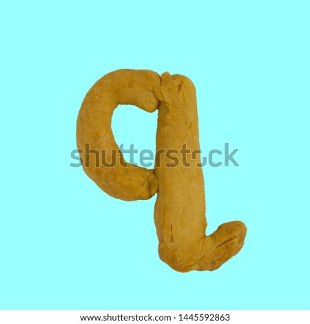 The letter q made from pastry, which can be eaten.
