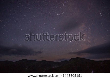 Starry sky at night over the mountains in the summer of the Carpathians