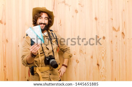 young crazy explorer against wood background