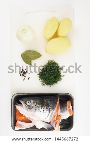 salmon head and tail, peeled potatoes, onions, dill, Bay leaf, black pepper ingredients set for cooking fish soup
