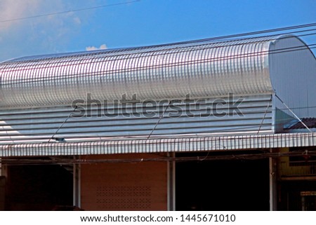 The metal sheet of building near the road