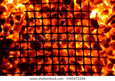 Bright orange background from burning coal anthracite and a laid lattice.
