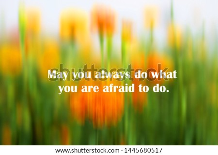 Inspirational motivational quote - May you always do what you are afraid to do. With abstract background of fresh blurry marigold flowers garden in yellow and green colors.