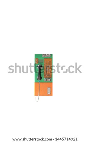 Green and orange color public telephone coin in Thailand isolated on white with clipping path