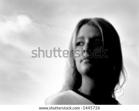 Beautiful young woman portrait in the setting sun;  black and white