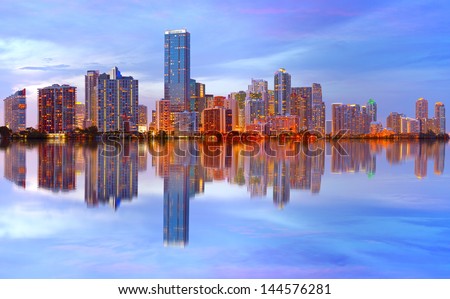  City of Miami Florida sunset over downtown illuminated business and luxury residential buildings, hotels with reflection .Night Cityscape of World famous travel location.