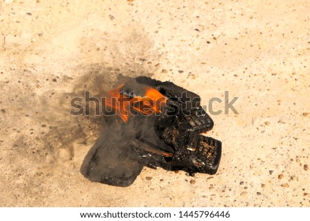 burnt mobile phones on a textural concrete background. Concept: Danger of using low-quality cell phones.