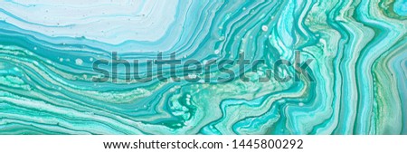 photography of abstract marbleized effect background. Blue, mint, gold and white creative colors. Beautiful paint. banner