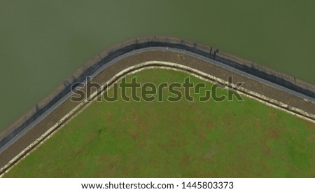 the bend of the dam looks like a boomerang from above using a drone camera