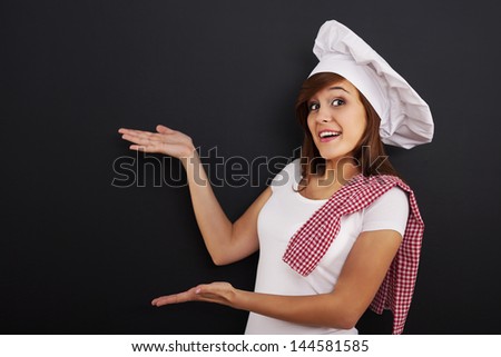Chef showing blank menu on blackboard