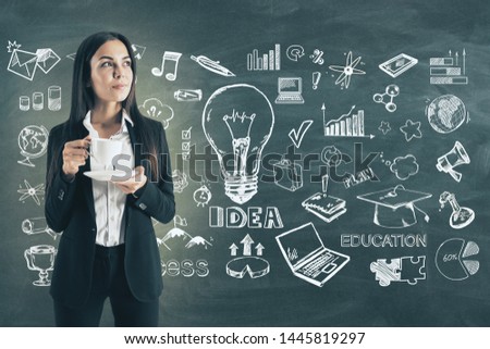 Portrait of happy young european businesswoman on chalkboard wall background with coffee cup and business sketch. Idea and solution concept