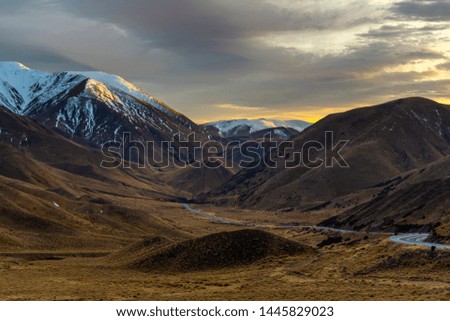 Snowy mountains at the top with beautiful valleys and curvy roads. At dawn the morning light made the pictures beautiful at Lindis Pass Viewpoint at Otago, New zealand