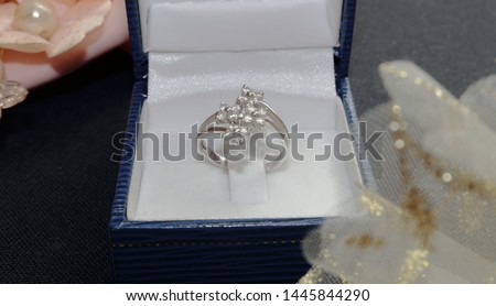 White gold wedding ring stands in one box ready for an engagement