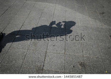 The shadow of people playing mobile phones