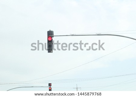 red traffic light on sky background