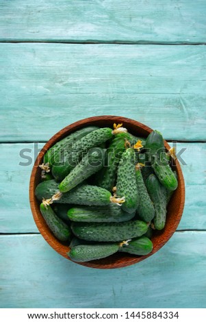 cucumbers in a bowl on wooden surface