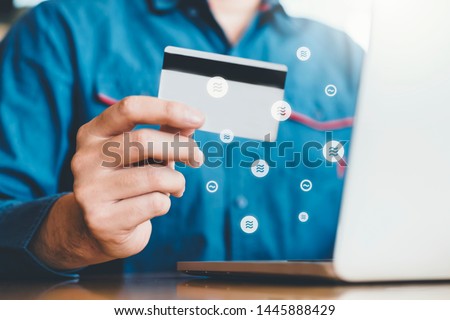 Libra Cryptocurrency Online banking businessman using Laptop with credit card online shopping , Fintech and Blockchain concept